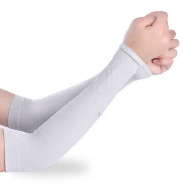 Person wearing light gray compression arm sleeves with thumb holes on raised fists
