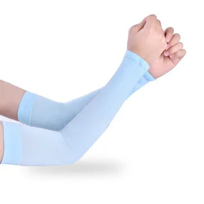 Person wearing light blue compression arm sleeves on both arms against white background