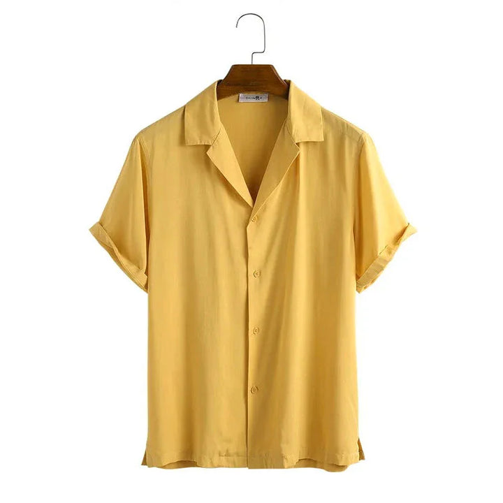 Yellow short sleeve button-up casual shirt on wooden hanger with rolled cuffs