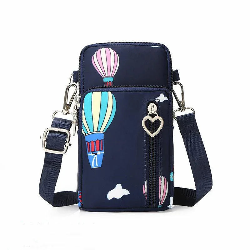 Navy blue crossbody bag with colorful hot air balloon print and heart-shaped zipper pull
