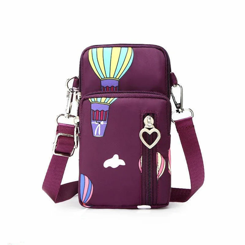 Purple crossbody bag with colorful hot air balloon print and heart-shaped zipper pull