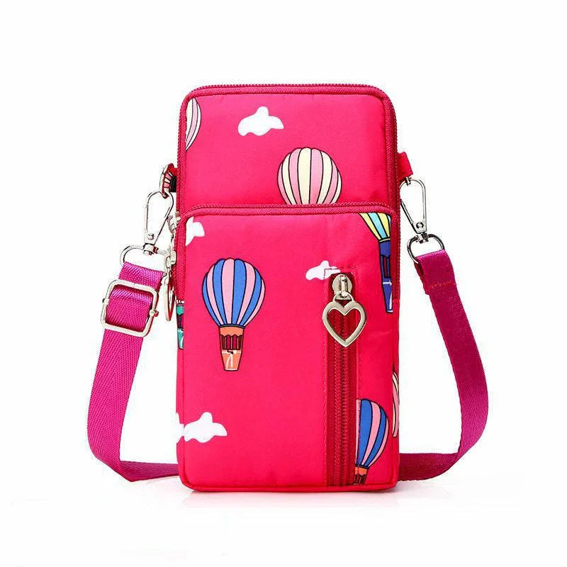 Bright pink crossbody bag with colorful hot air balloon print and heart-shaped zipper pull