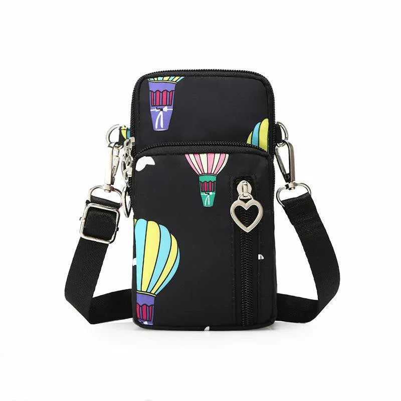 Black crossbody bag with colorful hot air balloon print and heart-shaped zipper pull