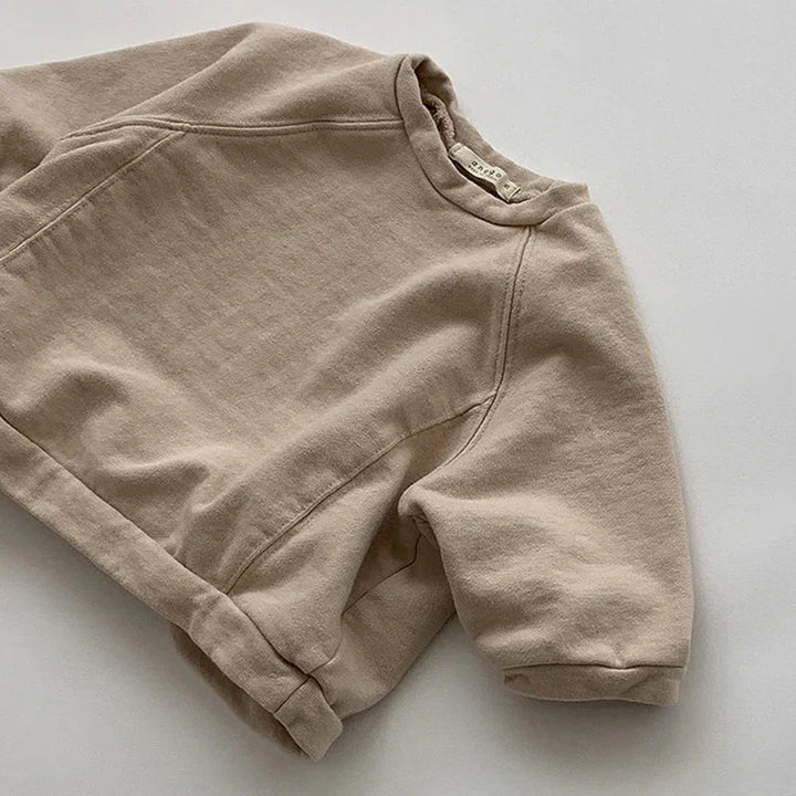 Beige short-sleeve sweatshirt with crew neck on white background, casual cotton top