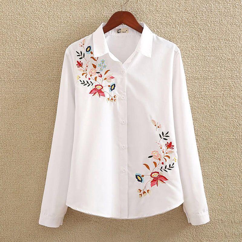 White long-sleeve button-up shirt with colorful floral embroidery on chest and hem