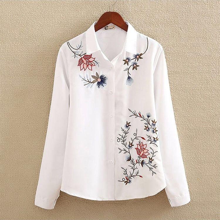 White long-sleeve button-up shirt with multicolor floral embroidery on front and collar
