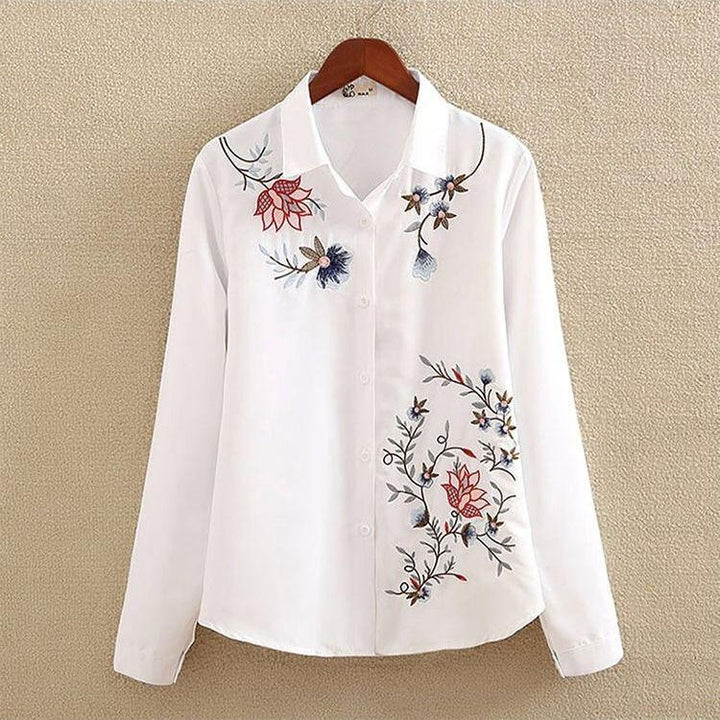 White long-sleeve button-up shirt with multicolor floral embroidery on front and collar