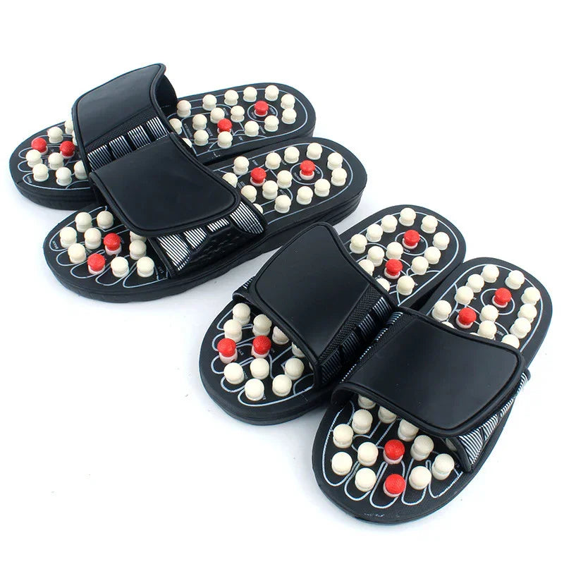 Black massage slippers with white and red acupressure nodes for foot therapy and pain relief