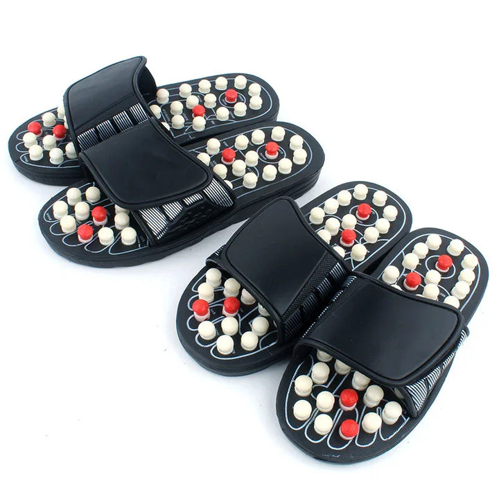 Black massage slippers with white and red acupressure nodes for foot therapy and pain relief