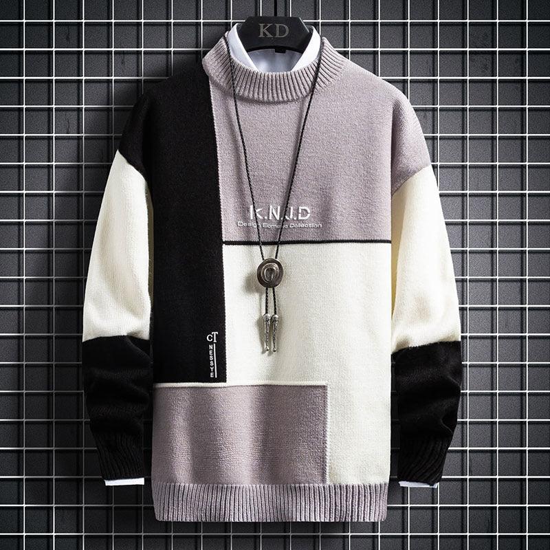 Men's color-block knitted sweater in black, white, and gray with geometric design and pendant necklace