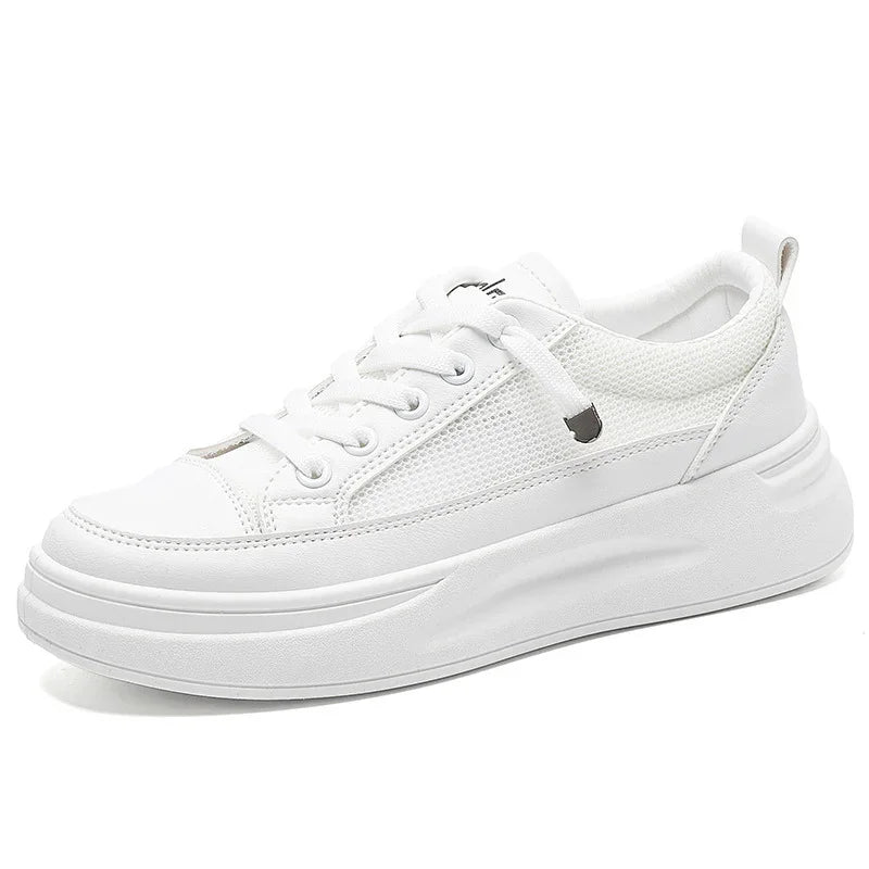 White casual sneaker with mesh panels, lace-up design, and chunky sole on white background