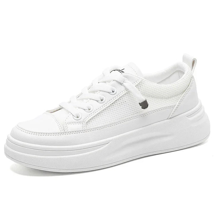 White casual sneaker with mesh panels, lace-up design, and chunky sole on white background