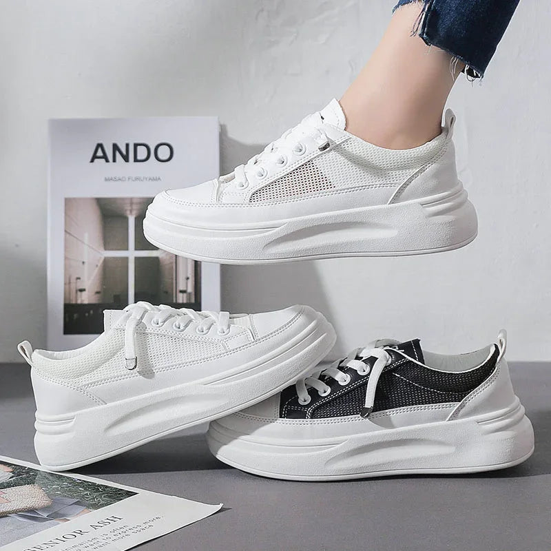 White and black mesh platform sneakers with thick soles displayed against a white background with minimalist decor
