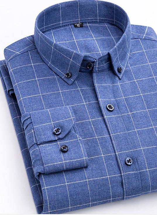 Folded blue button-down shirt with white checkered pattern and black buttons on white background