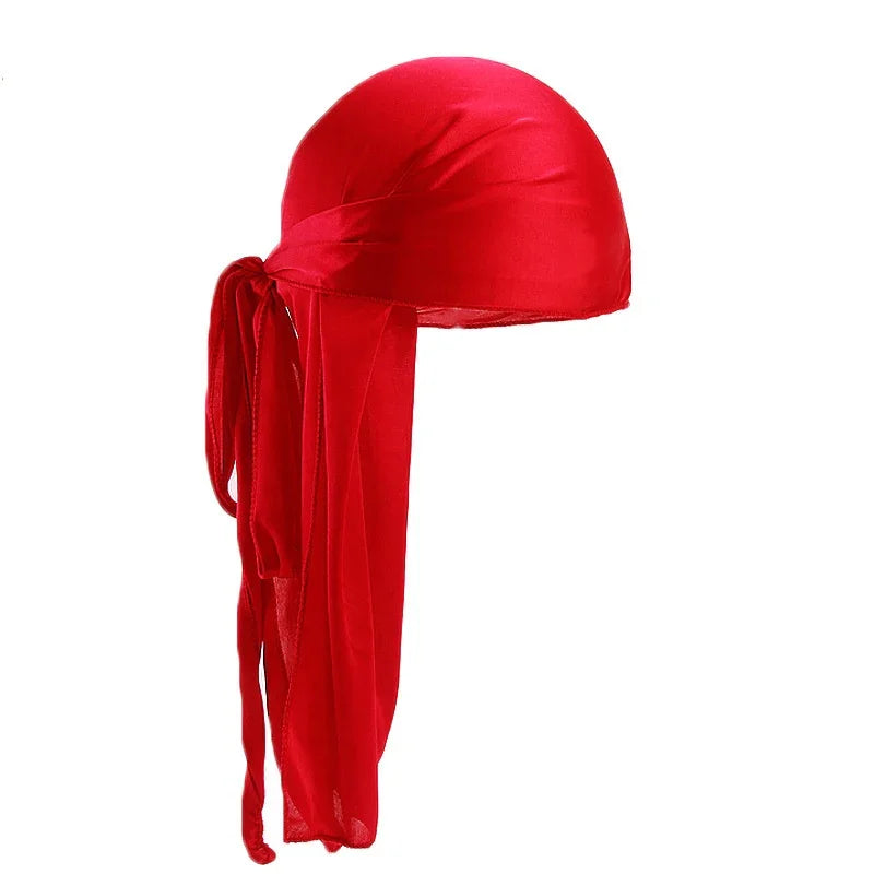 Red satin durag with long tails tied in a bow, mens silk wave cap on white background