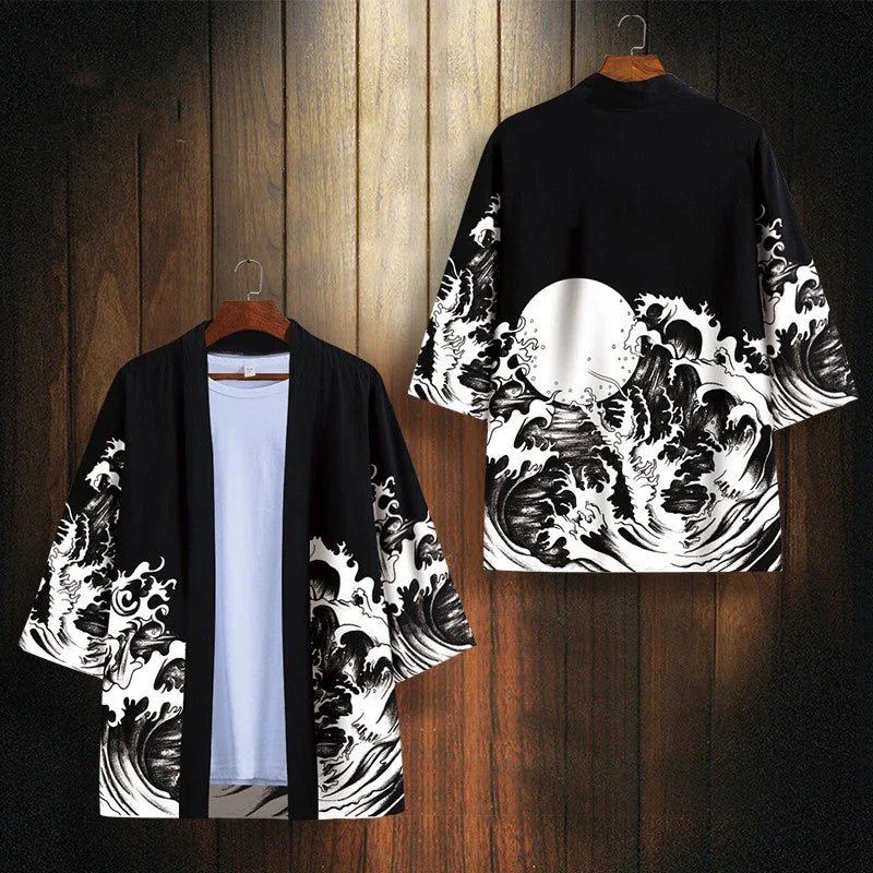 Black and white kimono jacket with ocean wave and full moon design hanging against wooden background