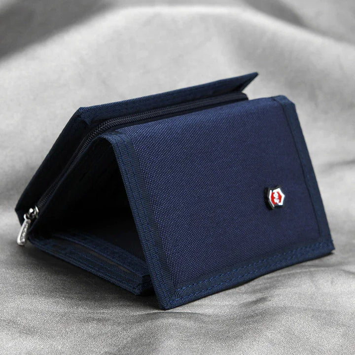 Navy blue fabric wallet with zippered compartment and hexagonal logo on gray surface