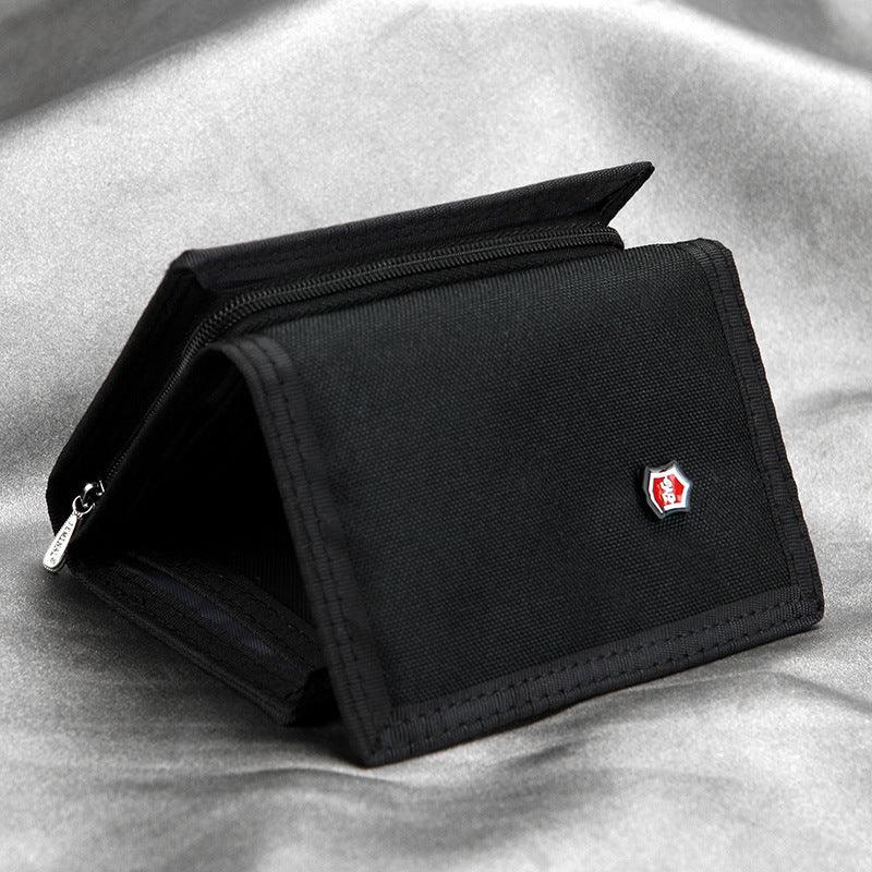 Black fabric wallet with red and white logo badge on grey textured surface