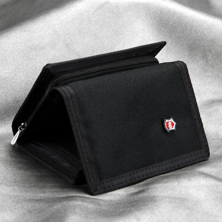 Black fabric wallet with red and white logo badge on grey textured surface