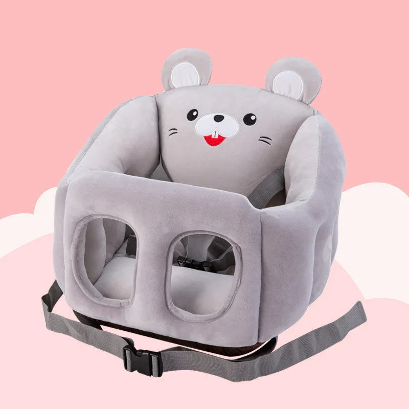 Gray plush baby floor seat with mouse face design and safety harness on pink background
