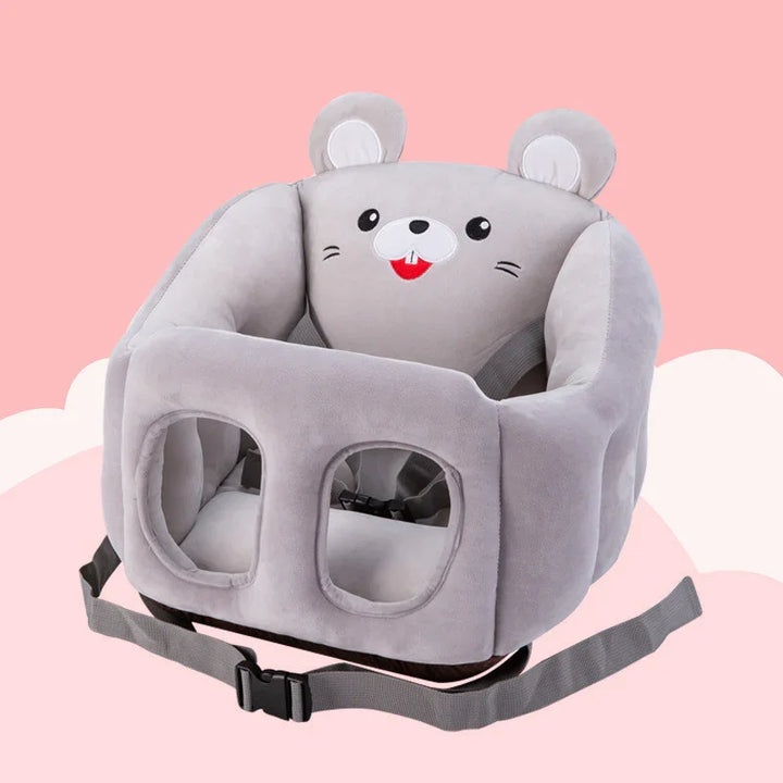 Gray plush baby floor seat with mouse face design and safety harness on pink background