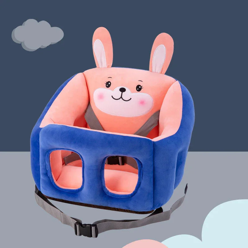 Plush baby safety seat with pink bunny face and blue sides, featuring a gray adjustable strap