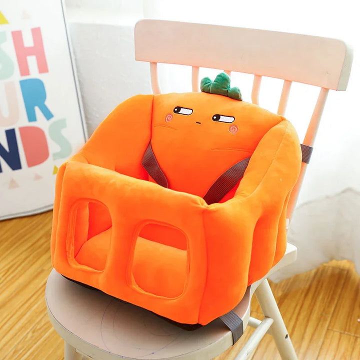 Orange plush baby booster seat with carrot design on white wooden chair in bright room