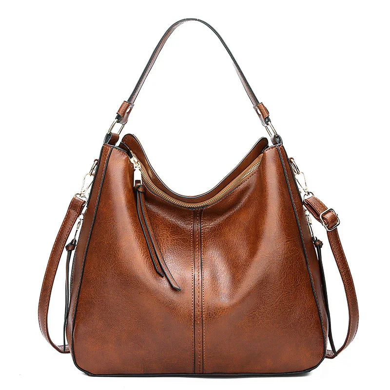 brown leather shoulder bag with adjustable strap and gold zipper detail