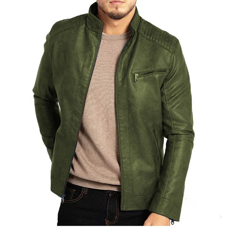 Man wearing stylish green leather jacket over beige sweater and black jeans against white background