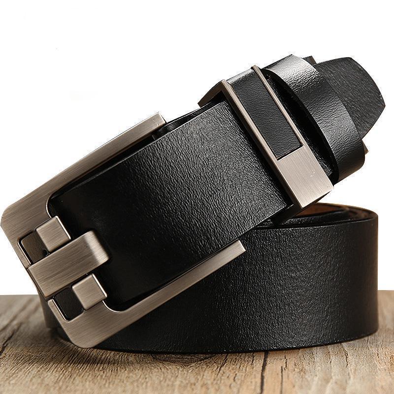 Stylish black leather belt with silver metal buckle on wooden surface