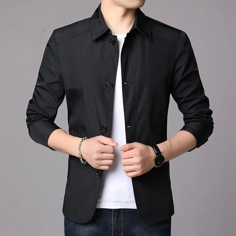 Man wearing slim-fit black casual blazer over white t-shirt with rolled-up sleeves and wristwatch