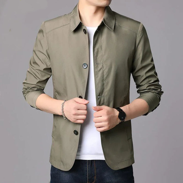Man wearing casual olive green button-up jacket with rolled sleeves and white t-shirt