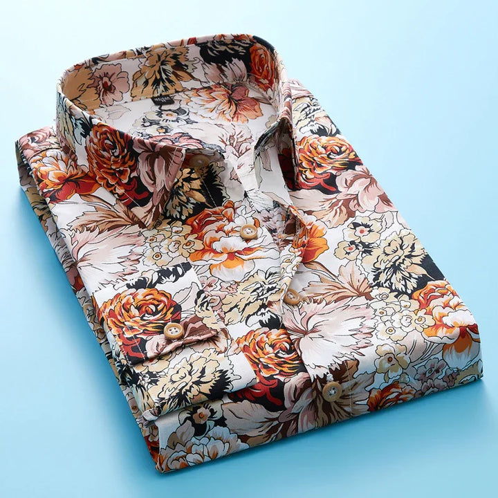 Folded men's floral print shirt with orange, brown, and beige flowers on light background