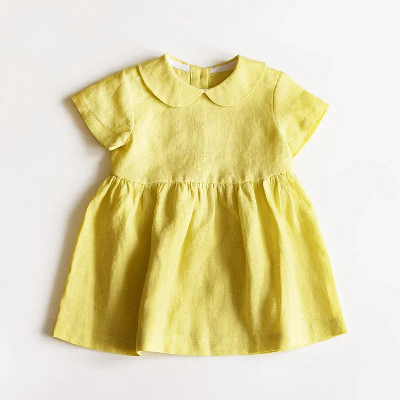 Yellow baby dress with short sleeves and Peter Pan collar on white background