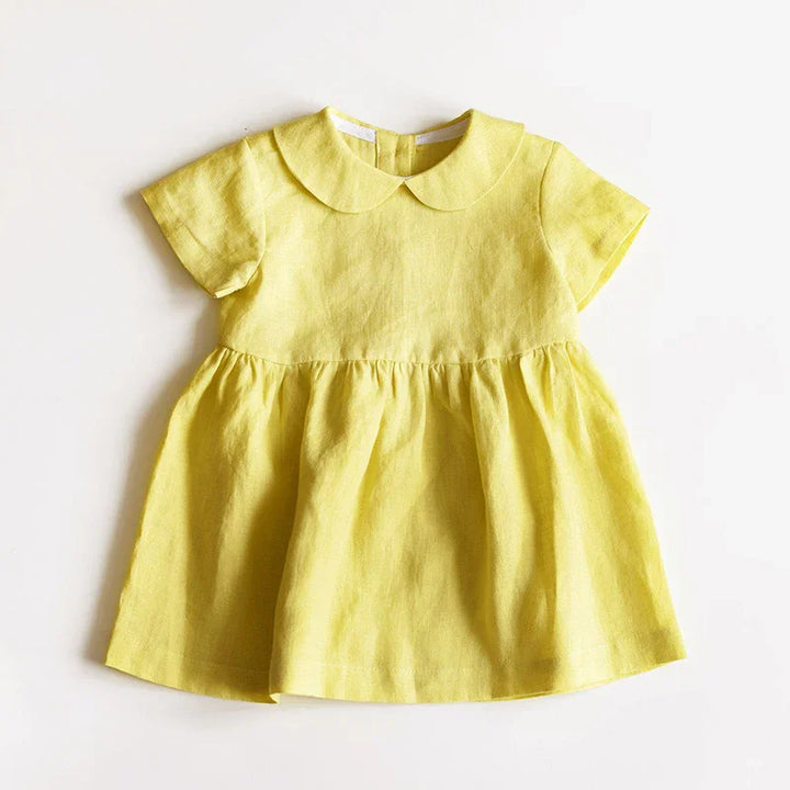 Yellow baby dress with short sleeves and Peter Pan collar on white background