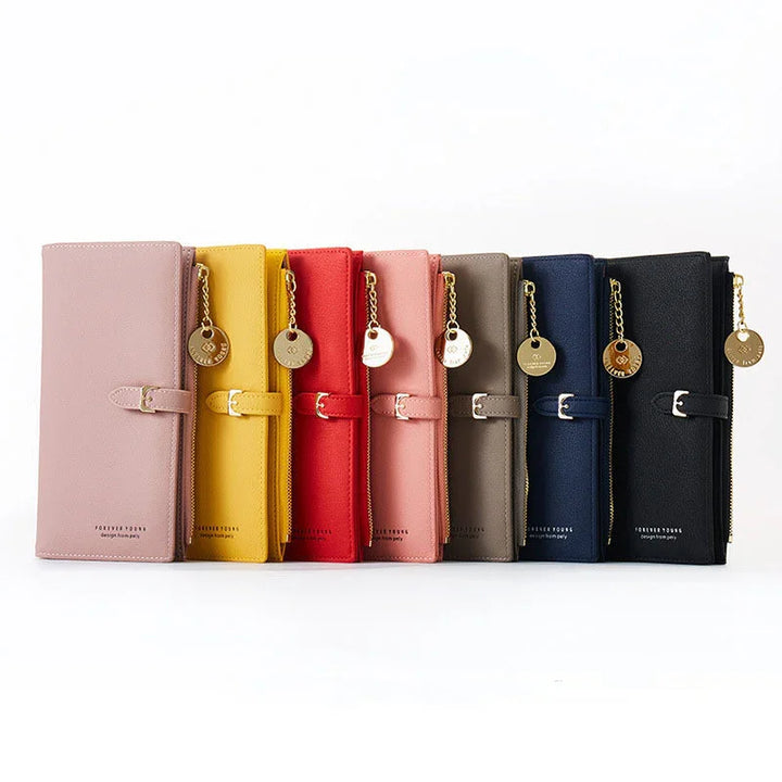 Row of stylish leather wallets in pink, yellow, red, blush, brown, navy, and black with gold zipper charms