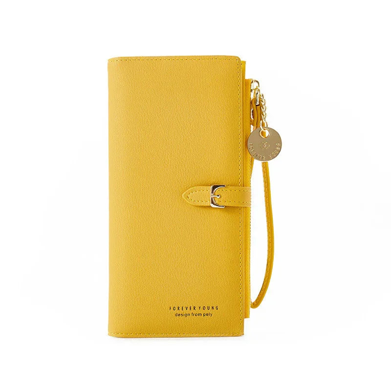 Yellow leather wallet with wrist strap, buckle closure, and gold charm, labeled Forever Young