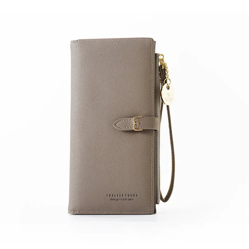 Taupe leather wallet with gold buckle and wrist strap on white background