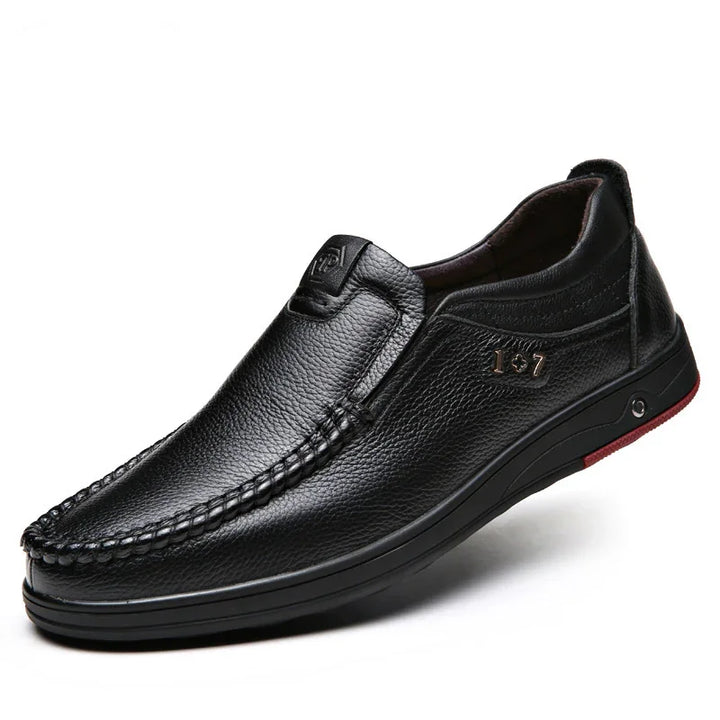 Black leather slip-on men's casual shoe with stitched detail and rubber sole
