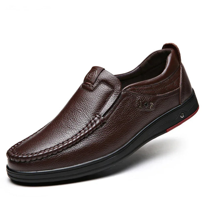 Brown leather slip-on men's casual shoe with detailed stitching and black sole