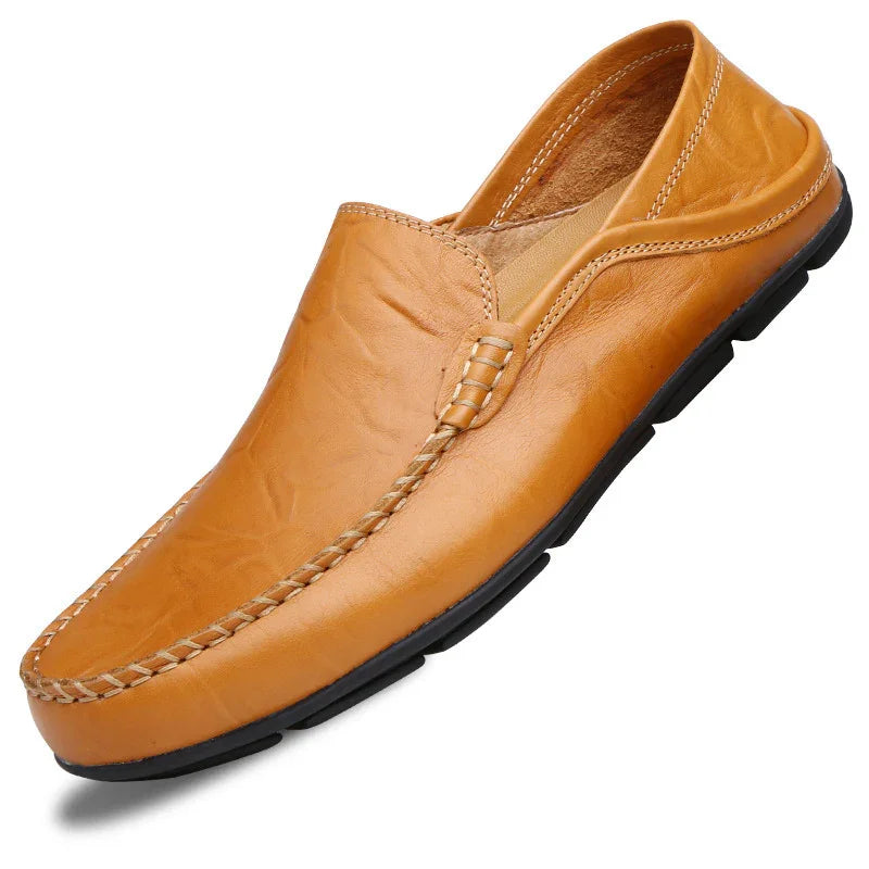 tan leather slip-on mule shoe with black sole and visible stitching details