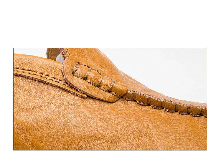 Close-up of tan leather loafer shoe with detailed stitching and moccasin-style design