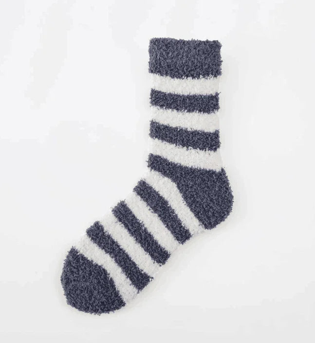 Cozy black and white striped fuzzy sock on white background, soft warm winter sock