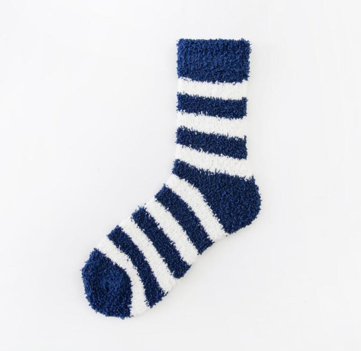 Fuzzy navy blue and white striped cozy sock laid flat on white background