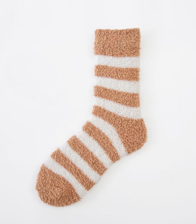 Cozy fuzzy sock with wide horizontal stripes in brown and white on a white background