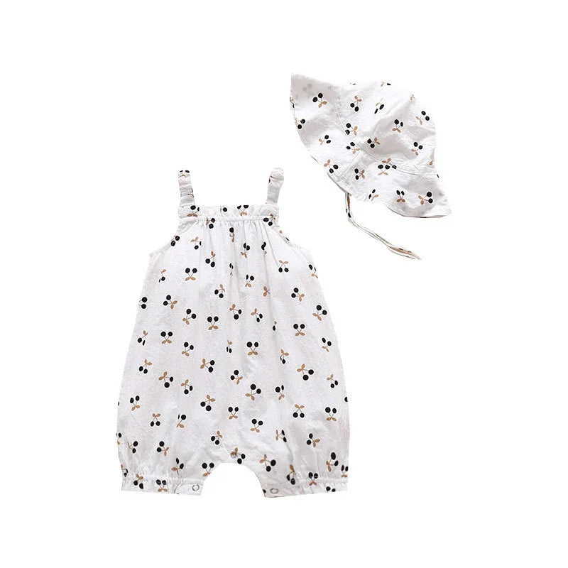 White baby romper and matching sun hat with black and beige cherry print pattern