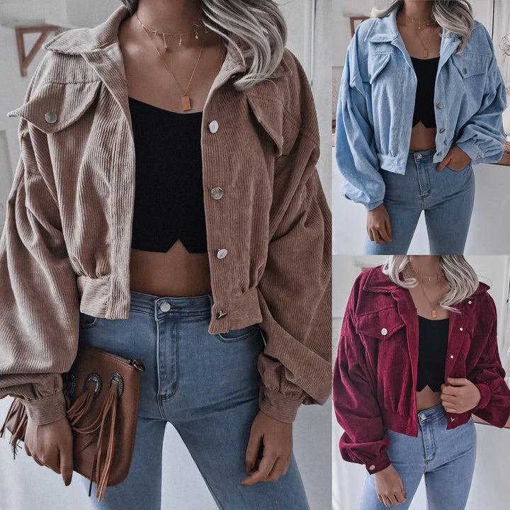 Women wearing cropped corduroy jackets in brown, blue, and red with high-waisted jeans and black crop tops