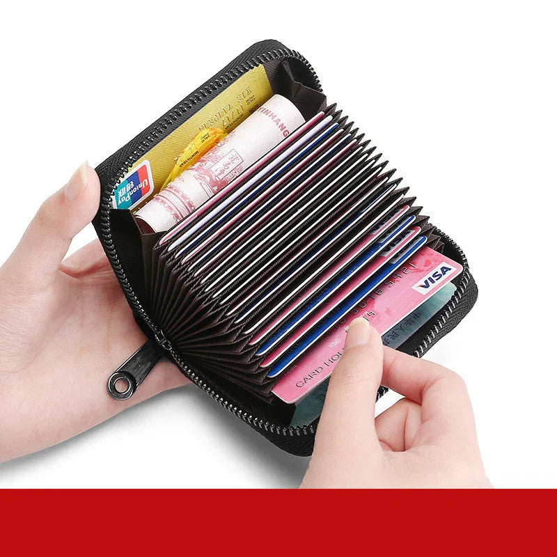 Hand holding black zippered accordion card holder wallet with multiple credit and bank cards inside