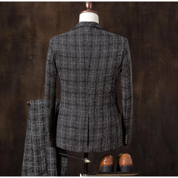 Back view of dark gray plaid men's suit jacket on mannequin with matching trousers and brown leather shoes