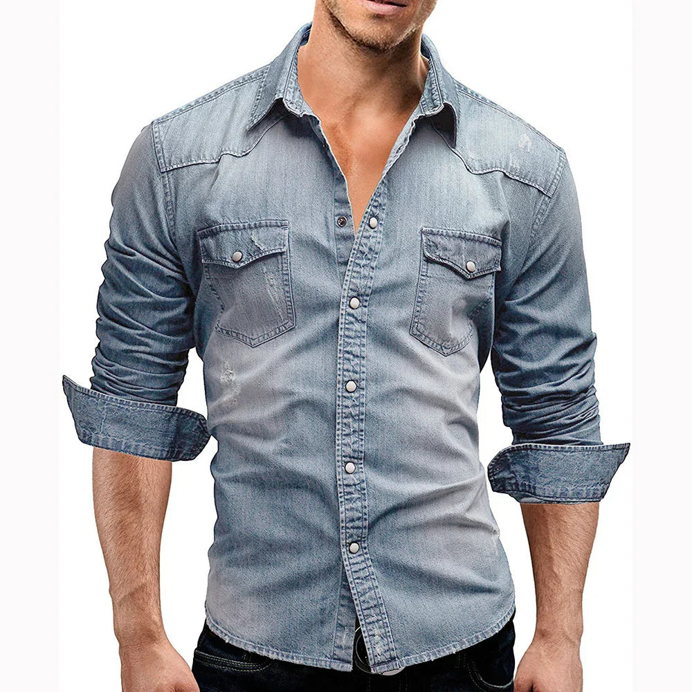 Man wearing light blue denim shirt with rolled-up sleeves and buttoned chest pockets